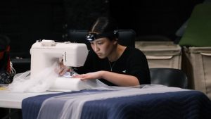 A young woman hard at work at a sewing maching