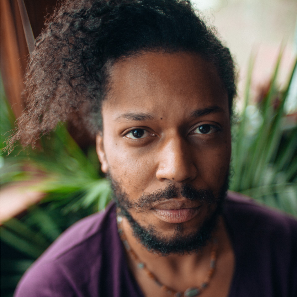 there is a close up of a man with a beard wearing a purple shirt