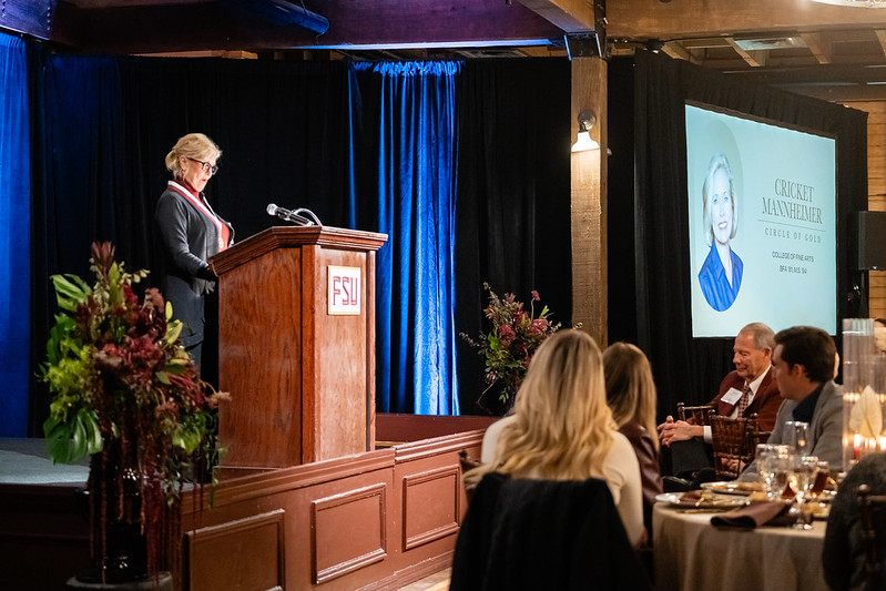 A woman at a podium during an awards event