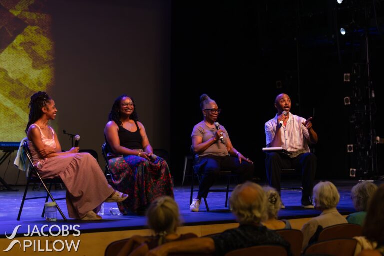 Four people sitting on a stage
