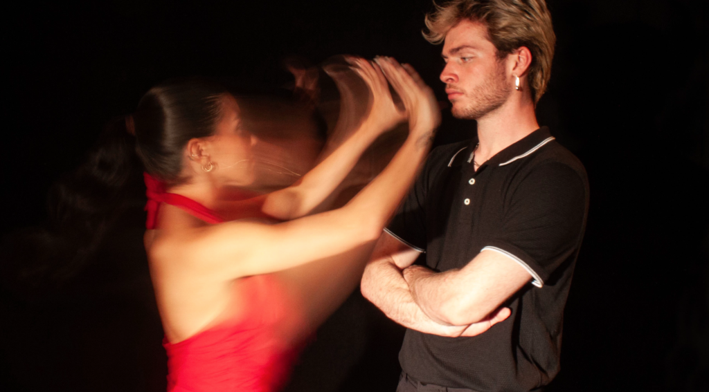 A man and a woman in a dance performance appear to be arguing