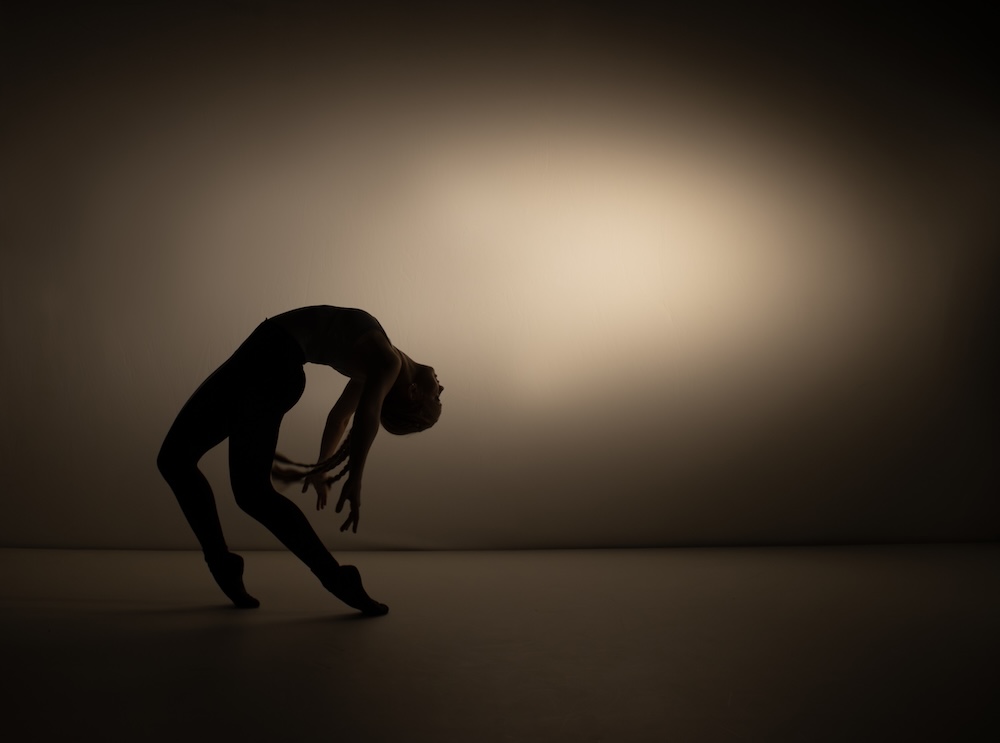 A dancer arching back