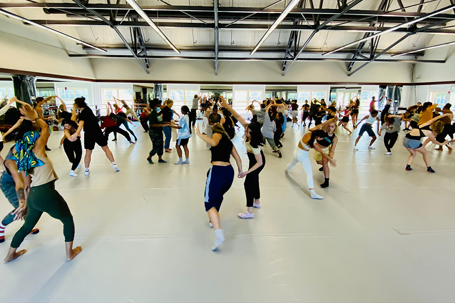 Dance students practice in a large room.